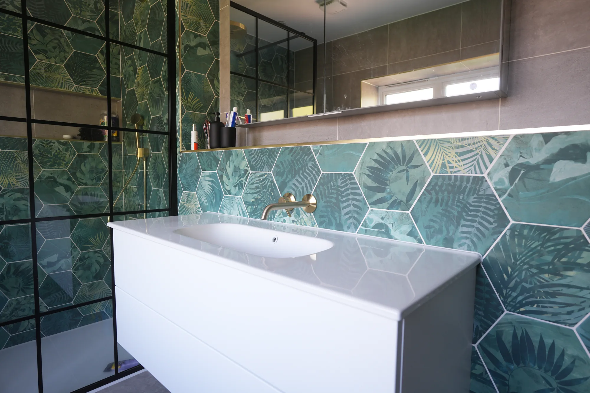 Vanity and black framed shower screen in the green tiled bathroom at our Brentwood project.