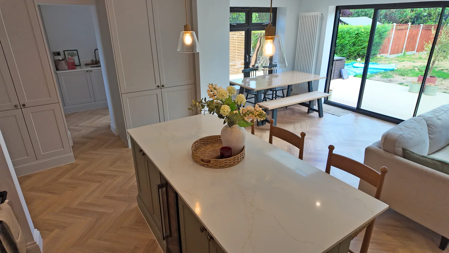 Kitchen island looking through to the dining area and garden in the Billericay rear extension
