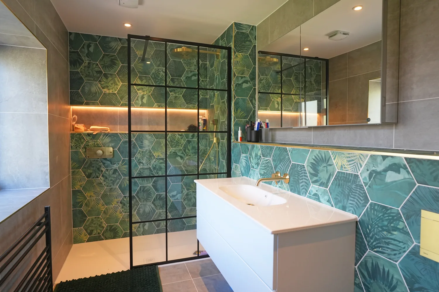 New bathroom at the Brentwood house with green hexagonal feature tiling and a black framed shower screen
