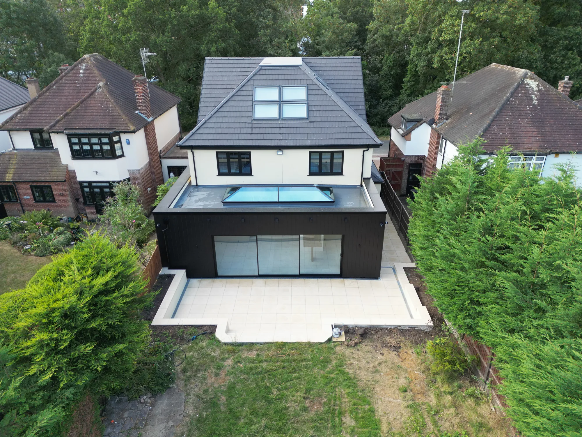 Aerial view of the Chigwell rear extension, flat roof lantern, full width sliding doors and porcelain patio