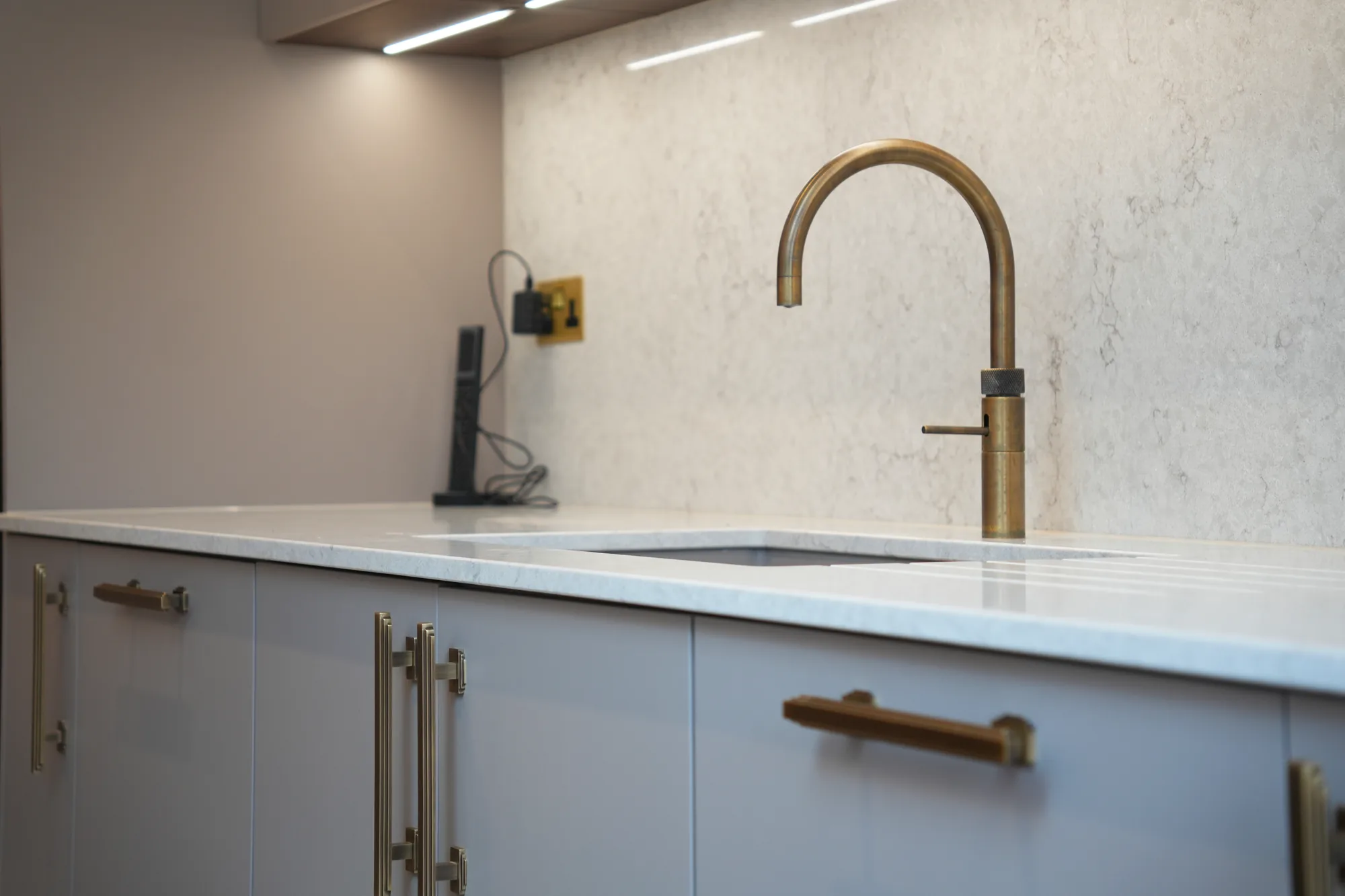 Brass tap and marble worktop detail in the Chigwell kitchen.
