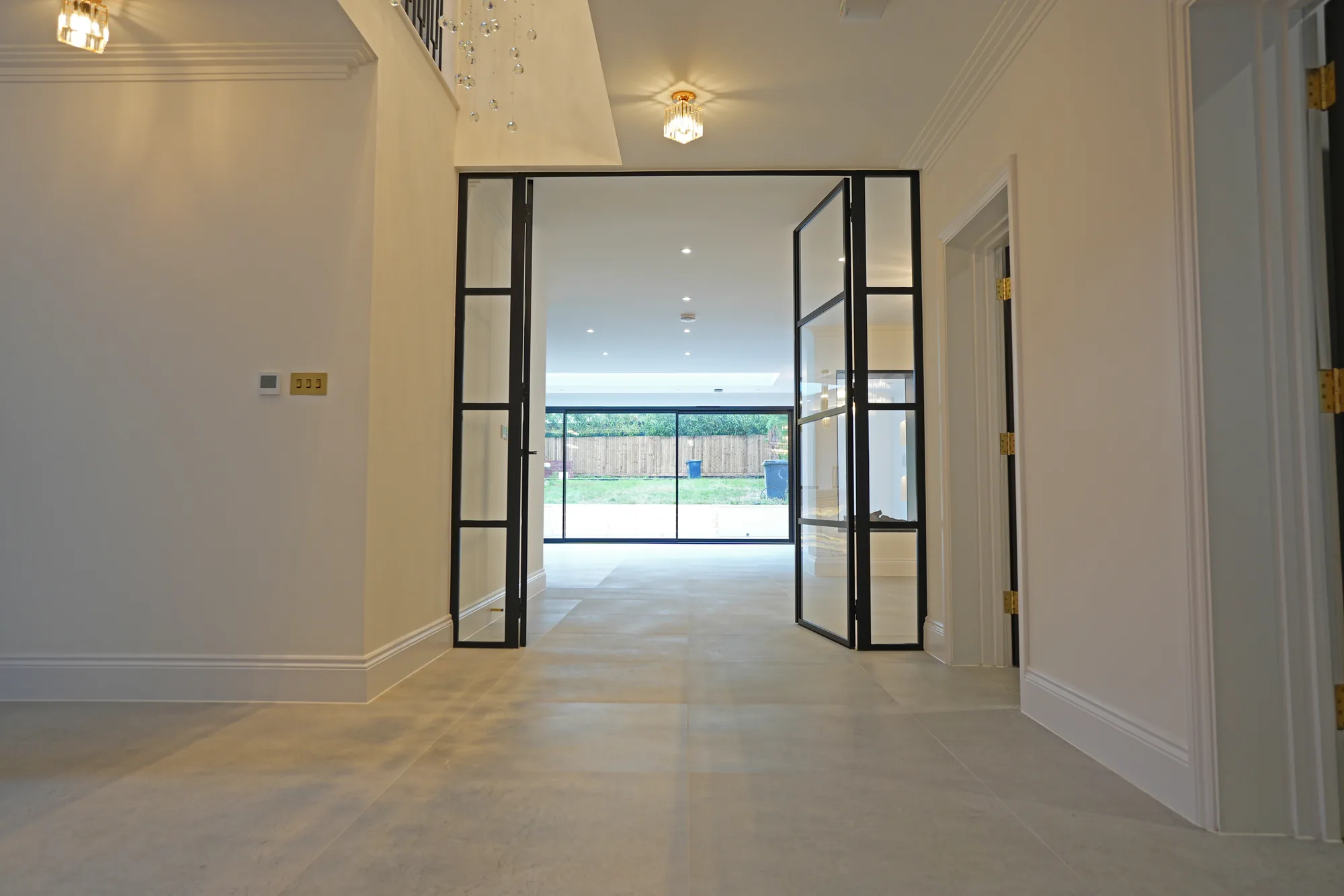 Full height glazed doors leading from the Chigwell entrance hall to the open plan living space