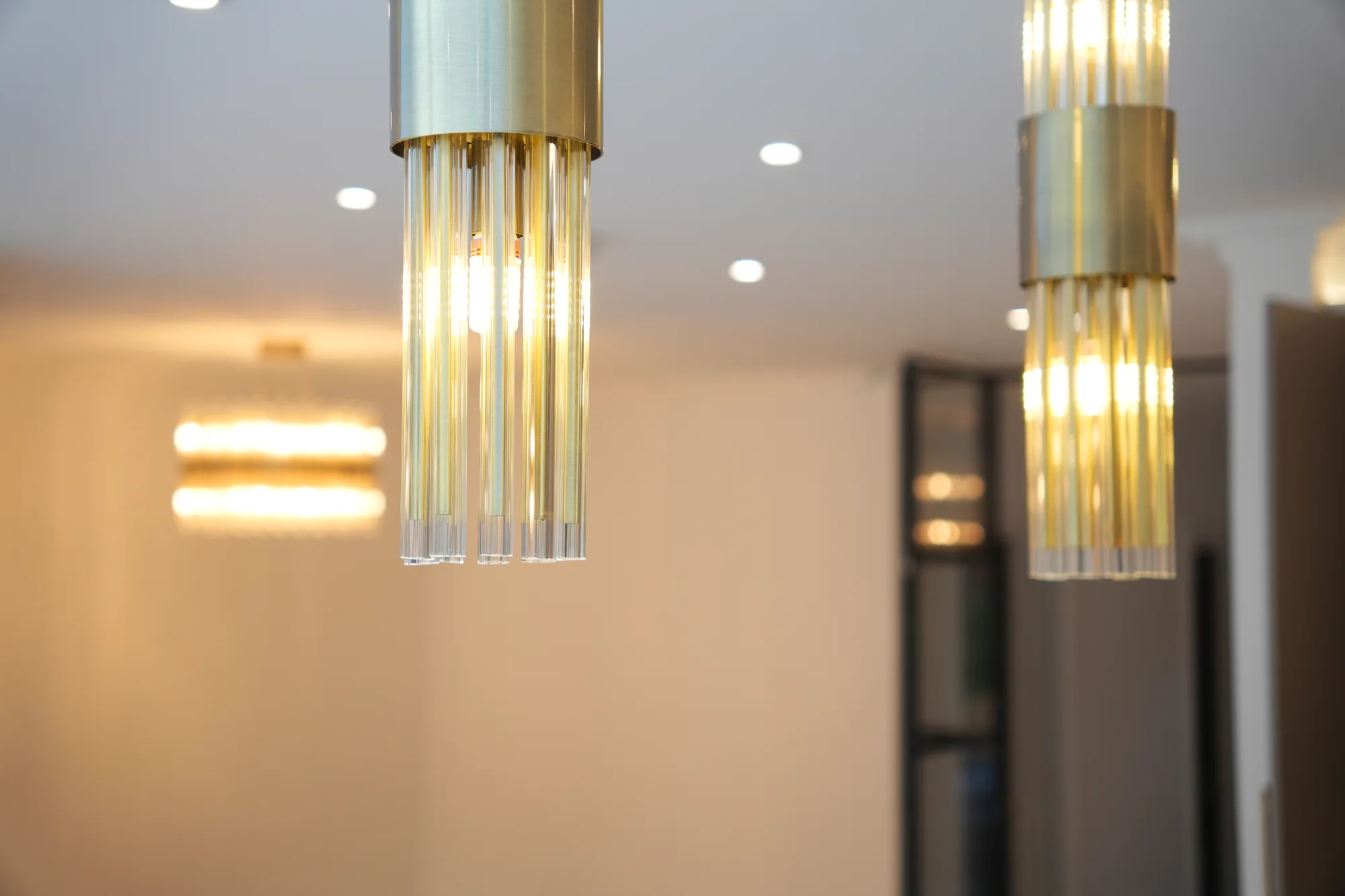 Fluted brass and glass pendant lights at the Chigwell project