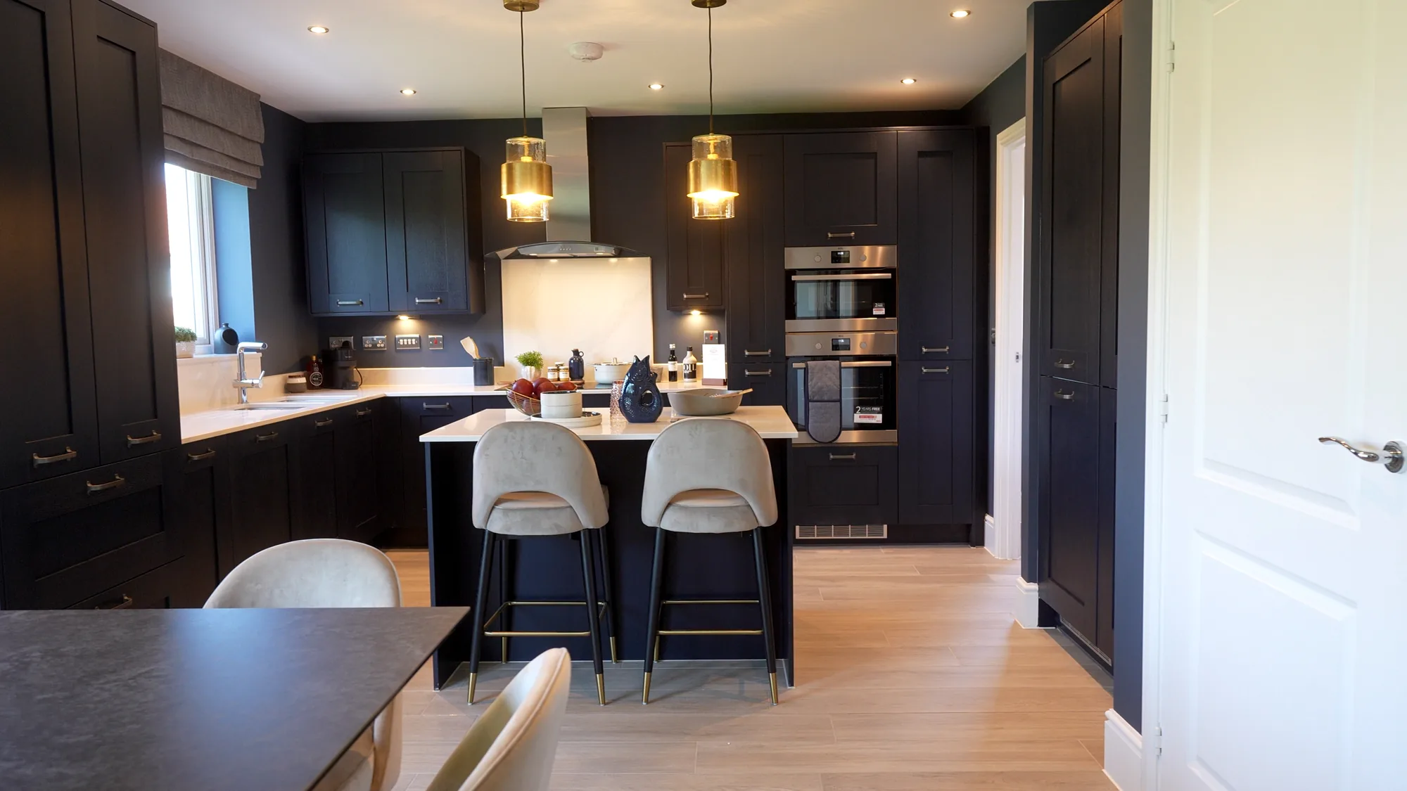 Dark cabinetry kitchen with feature lighting.