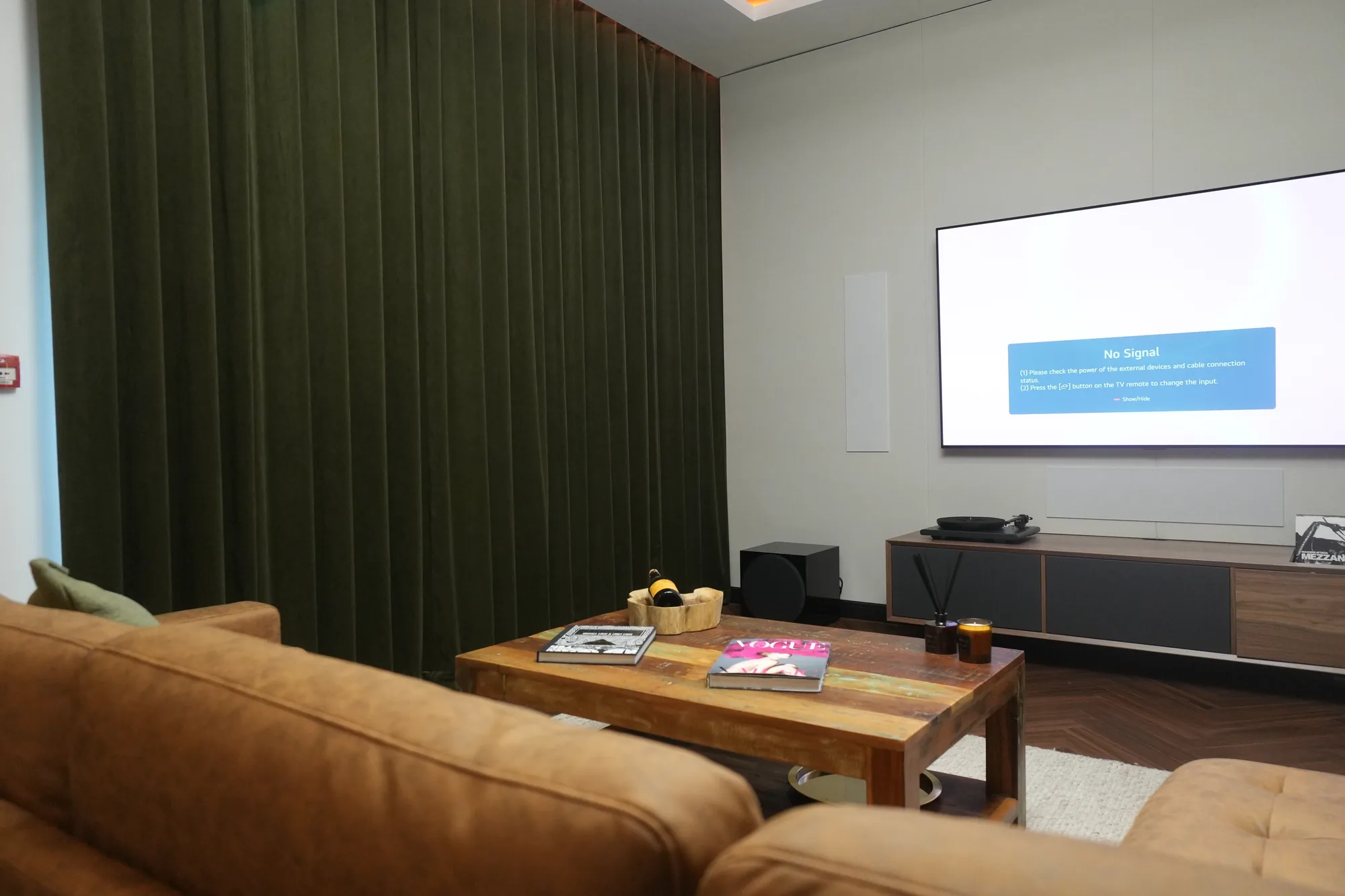 Media lounge in the Monitor Audio show unit with acoustic drapery and media wall