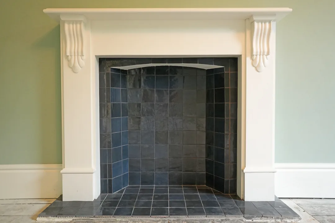 Restored fireplace with slate tiled inset at the 1850s Wickham Bishops house.