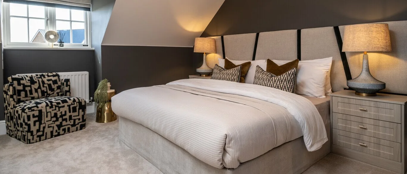 Finished show home bedroom with upholstered headboard at The Foxgloves, Silver End
