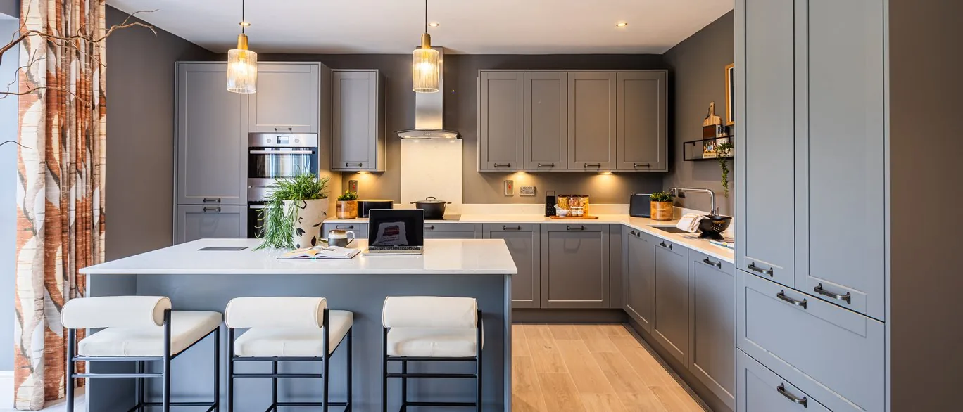 Finished show home kitchen with grey shaker units and island at The Mulberries, Witham