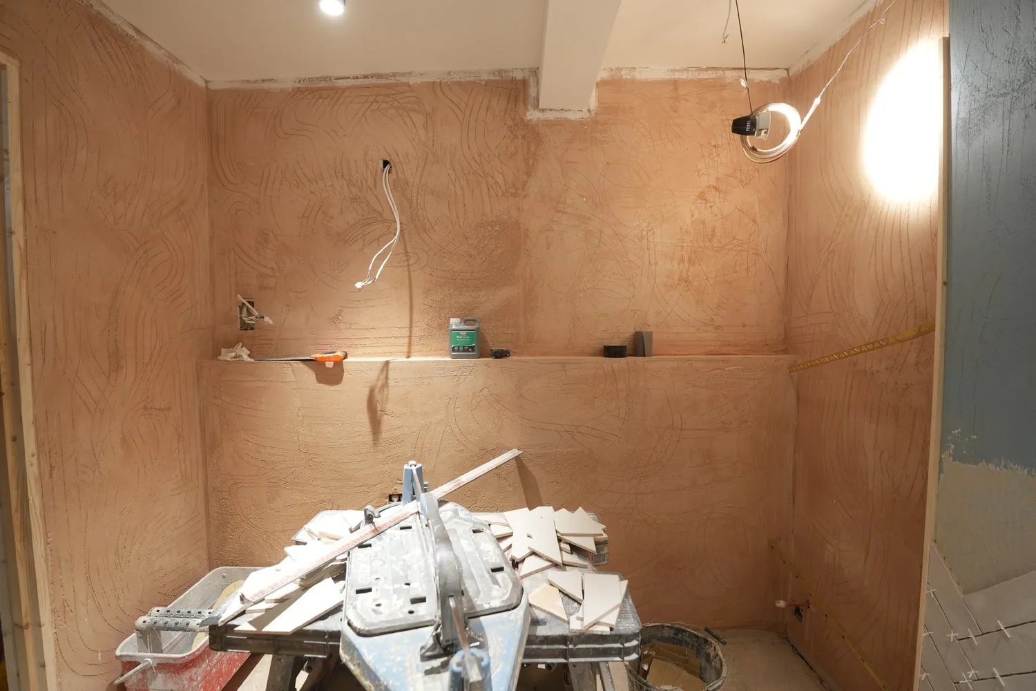 A Brentwood shower room boarded out ready for tiling, the tile cutting station set up mid fit out.