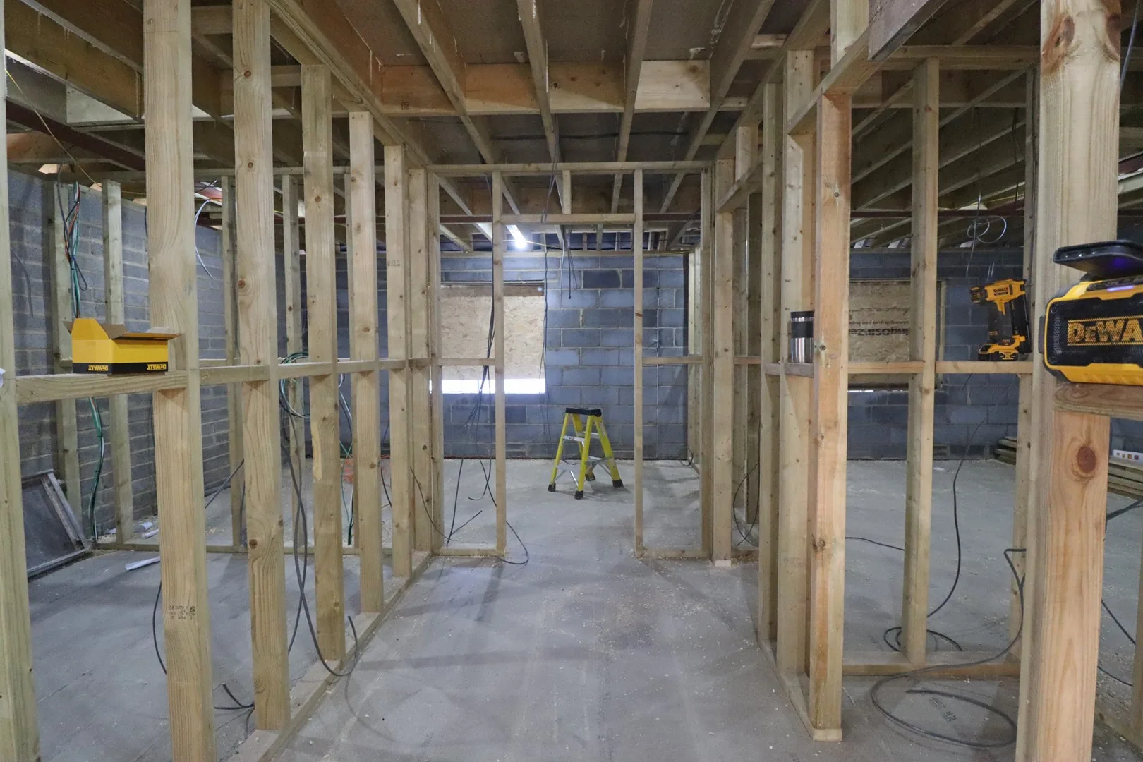 First fix stud framing marking out a new room at Chigwell, timber partitions against the blockwork shell.