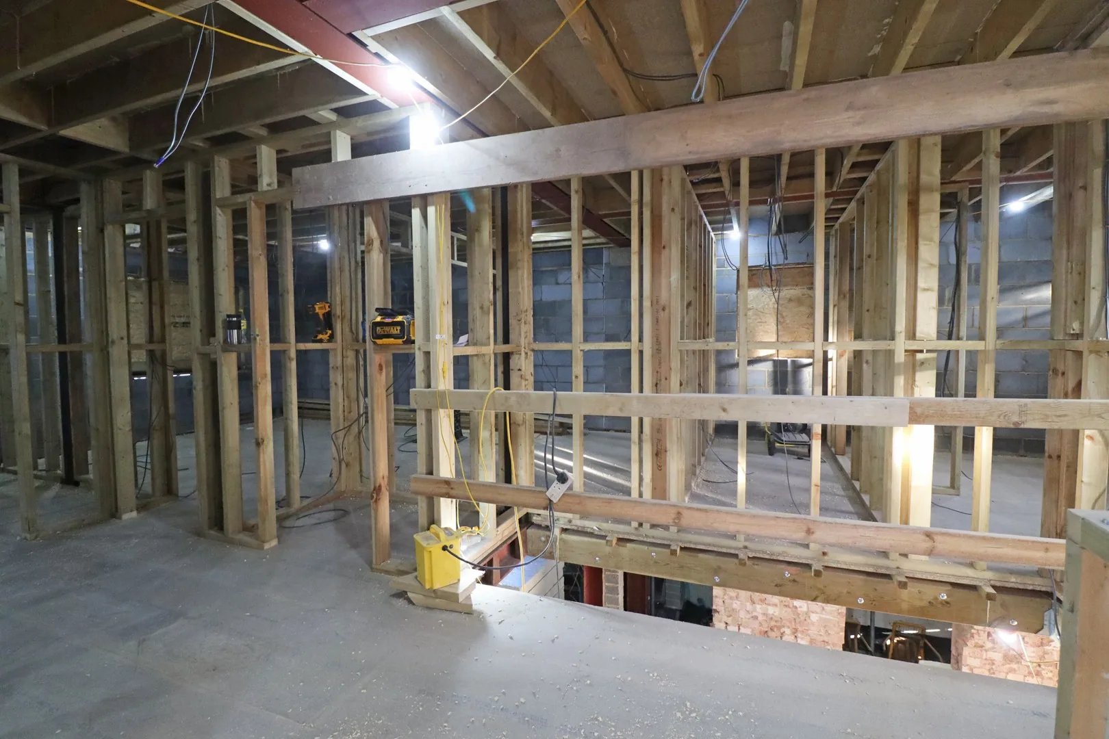 Stud wall first fix on an upper floor at Chigwell, new timber partitions and door openings framed around the stairwell.