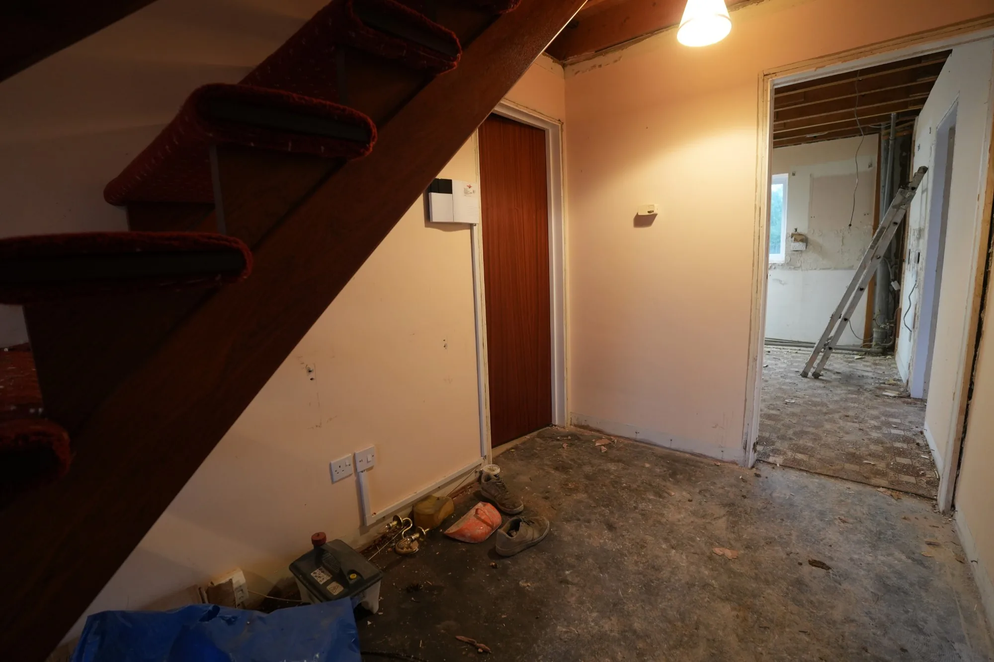 Under the old staircase at Cold Norton: dated joinery and lifted floors at the start of the work.